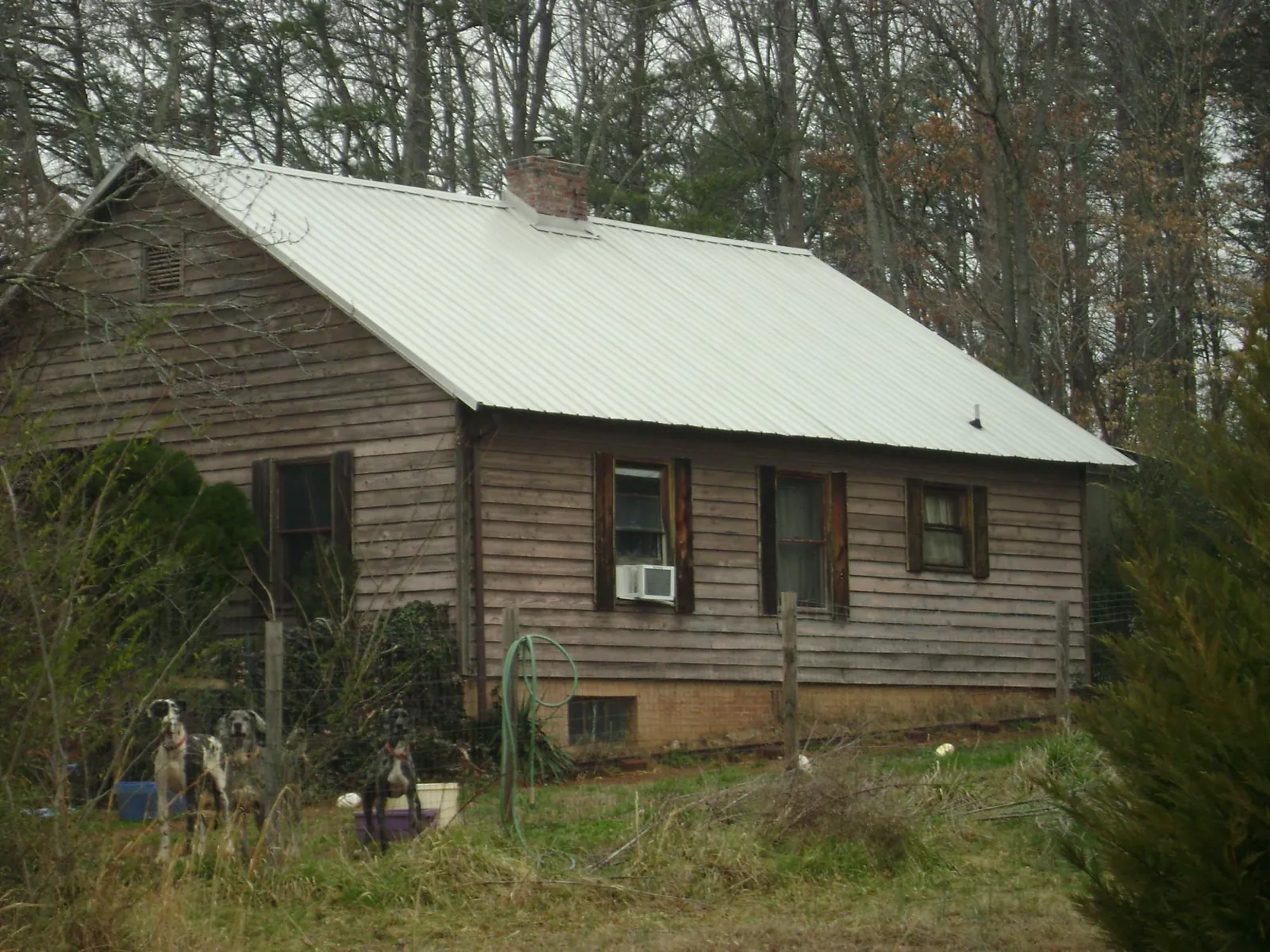 White metal roof on an old wood sided farmhouse, from a Metal Roof Installation job in East Sparta